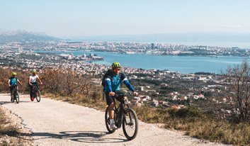 cyclists on uphill part with Split in the background